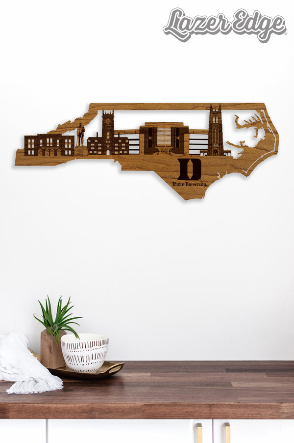 a wooden wall art depicting the skyline of North Carolina, with the Duke University logo prominently displayed.