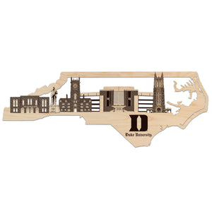 A wooden cutout of the skyline of Duke University, featuring various architectural landmarks and buildings.