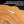 Load image into Gallery viewer, a wooden surface with a metal bracket attached to it, indicating that a pre-installed sawtooth-style hanger is being used for installation.
