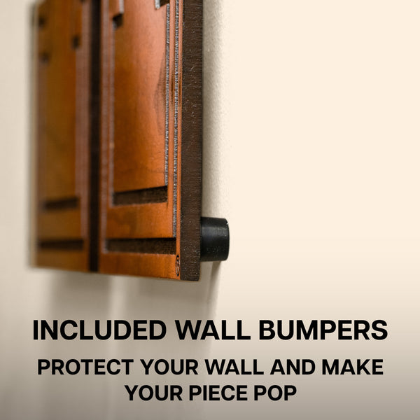 a wooden door with a text overlay that reads "INCLUDED WALL BUMPERS PROTECT YOUR WALL AND MAKE YOUR PIECE POP".
