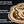 Load image into Gallery viewer, a close-up of a wooden object, possibly a piece of furniture or a decorative item, with a detailed engraved design on it.
